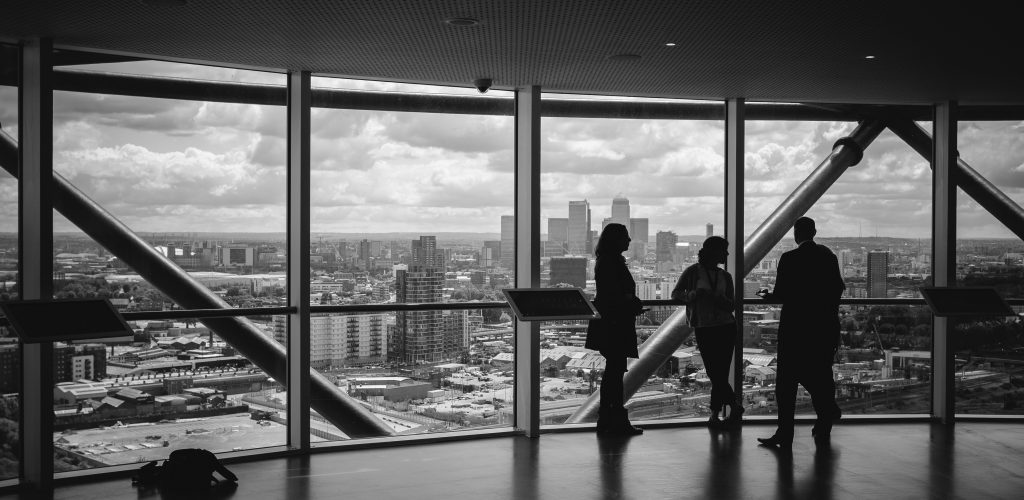 People looking out over the city from a building