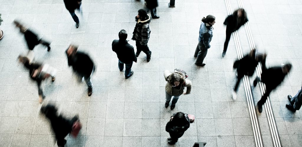 working professionals walking by each other indoors